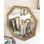 A modern gilt framed octagonal wall mirror with bevelled plate