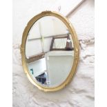 A gilt framed bevelled oval wall mirror