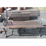 A modern garden bench with cast iron ends and wooden slatted seat