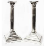 A pair of 28.5cm high silver Corinthian column candlesticks with detachable nozzles and loaded