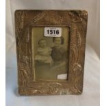 A Chester silver fronted photograph frame with Art Nouveau style wheat and floral decoration, with