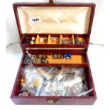 A concertina action jewellery box containing a large quantity of assorted costume jewellery
