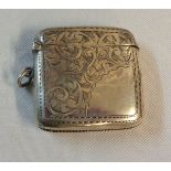A silver flip-top vesta case of curved form with blank cartouche and engraved decoration