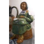 A 19th Century Low Countries majolica figural butter dish moulded in the form of a lady seated on
