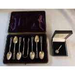 A cased set of six ornate silver teaspoons and pair of sugar tongs to match, with foliate pattern