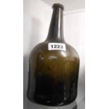 An antique green glass wine bottle of mallet form with long neck and kick-in base