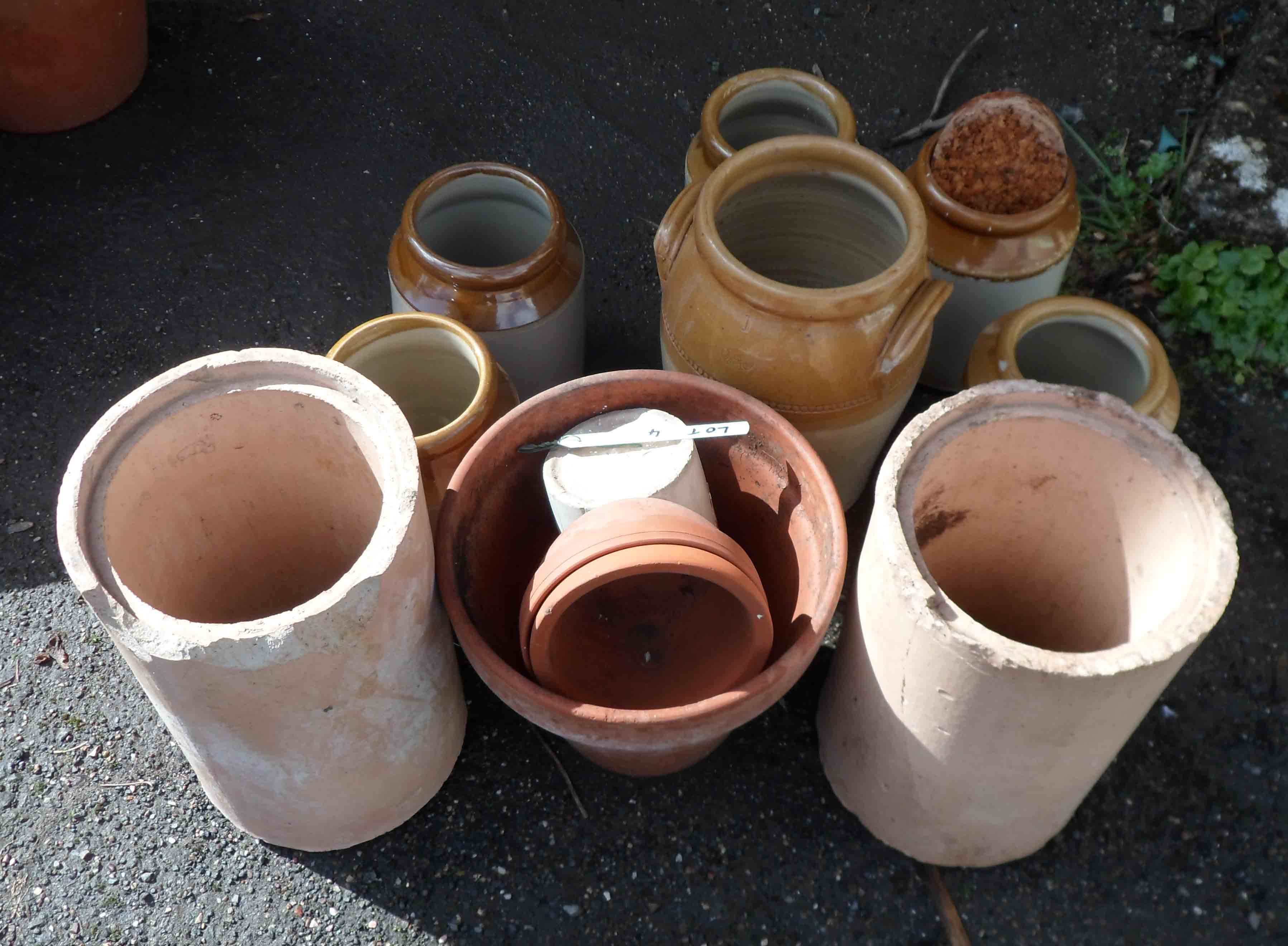 A selection of Bristol glaze storage jars, terracotta flowerpots, etc.