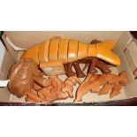 A box containing a quantity of carved wooden animals including pig corkscrew, elephant,