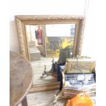 An old gilt framed oblong wall mirror with all over carved fruit decoration - 98 x 72cm