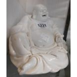 An antique Chinese porcelain blanc de chine Hotei figurine