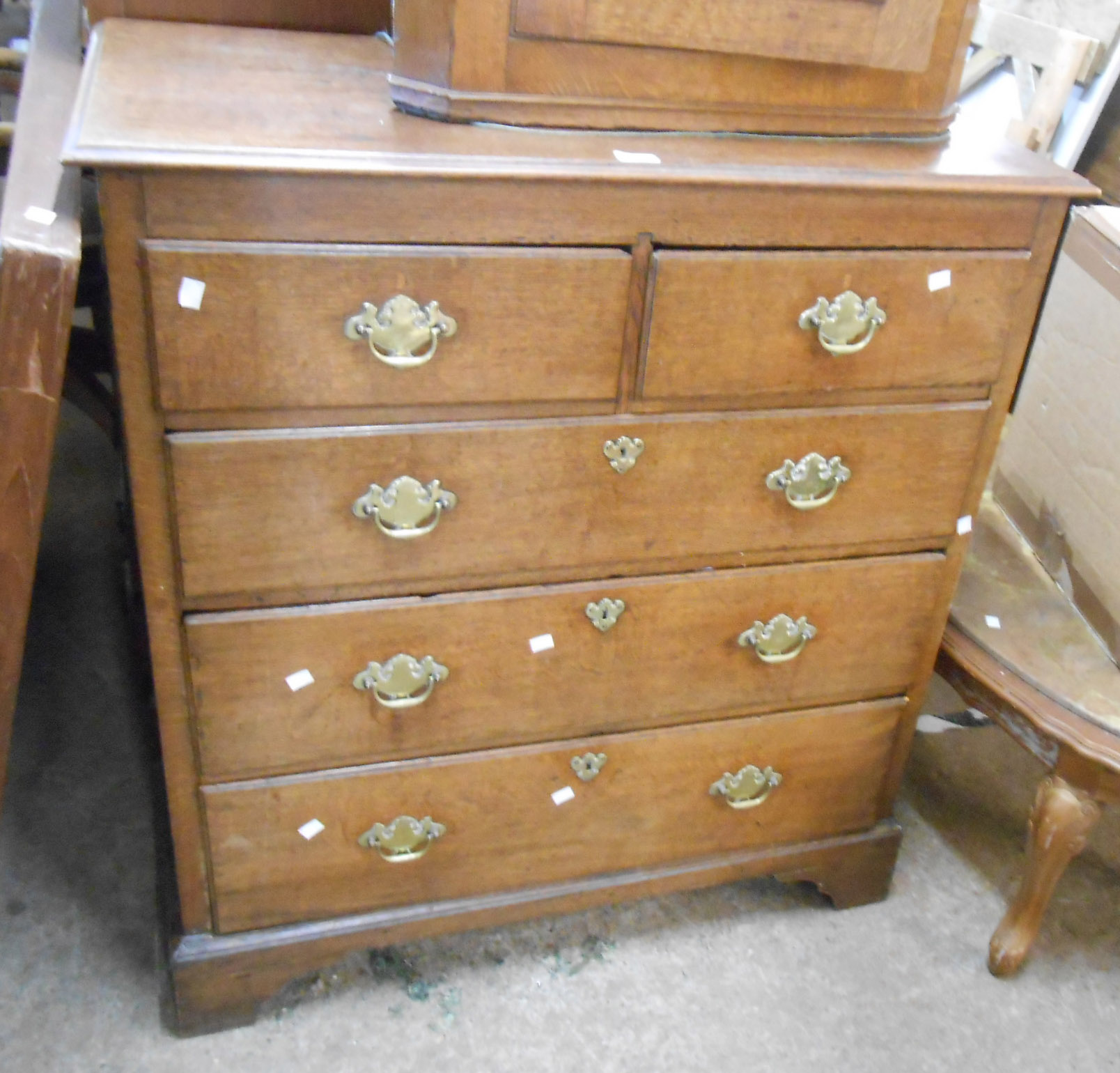 A 97cm late Georgian oak chest of two short and three long graduated drawers, set on bracket