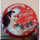 A modern printed tinCoca Cola sign in t A modern printed tin Coca Cola sign in the form of a