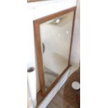 A large vintage oak framed bevelled oblong wall mirror