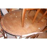 A 1.5m reproduction mahogany and strung pedestal tilt-top dining table, set on turned pillar and