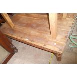 A 1.35m Eastern hardwood coffee table with iron studded decoration and bracketed turned legs - for