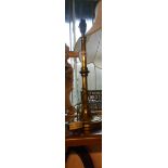 An old cast brass table lamp of tall candlestick from - sold with a modern brass table candlestick