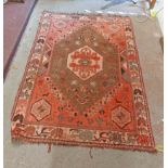 A handmade Persian wool rug with central knot shield with animal and flower decoration and