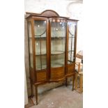 A 1.15m Edwardian inlaid mahogany break bow front display cabinet with material lined interior