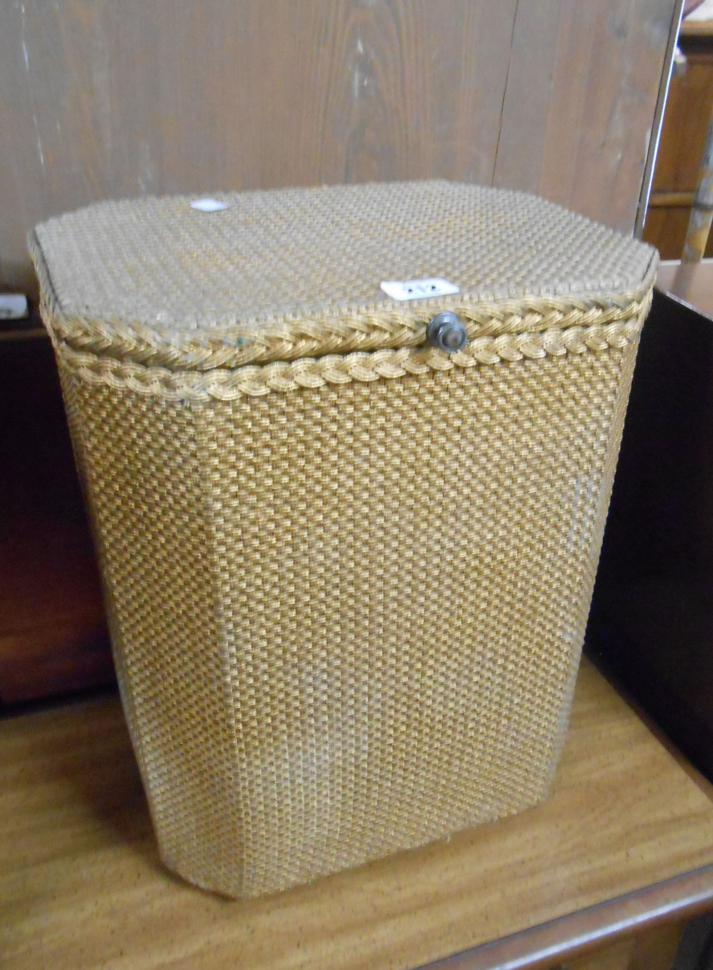 A 37cm vintage Sirrom loom style laundry basket with linen contents and original gilt finish