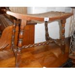 A mahogany dressing stool with curved seat and woven rattan panel, set on barley twist supports -