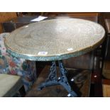 A 60cm diameter 20th Century Islamic tray style table top, set on a painted cast iron trefoil base