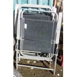 Four metal folding chairs with grey paint finish