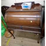 An 84cm Edwardian walnut roll-top bureau with fitted interior and two frieze drawers, set on