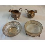 Two silver cream jugs, a silver pierced bon bon dish and a silver butter dish with etched and cut