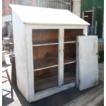 A large old pine scullery cupboard of plank construction with sloping roof and double doors to front