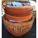 A small terracotta garden planter of reeded form - sold with two other garden plant pots