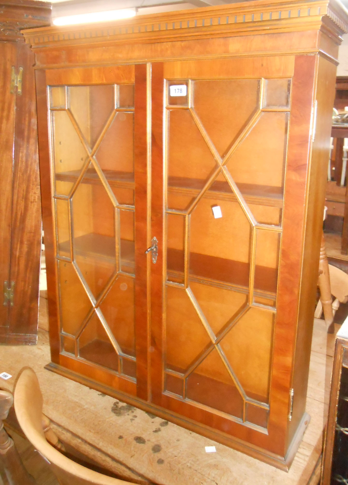 A 76cm reproduction yew wood bookcase top with shelves enclosed by a pair of astragal glazed panel