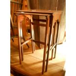 Two reproduction mahogany and strung tea tables, set on slender supports - from a nest