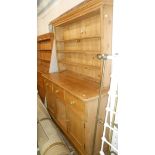 A 1.5m 20th Century pine two part dresser with three shelf open plate rack over a base with three