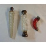 Two silver topped hobnail cut glass scent bottles, one of tapered form, the other double-ended -