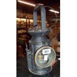 An antique railway hand lamp with black painted finish