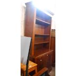 A 91cm reproduction mahogany two part bookcase with three open shelves to top over a base with