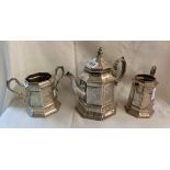 An early Victorian silver three piece tea set of faceted design with all over ornate engraved