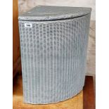 A Lloyd Loom corner laundry basket with later sprayed silvered finish and original label
