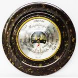 A 20cm diameter serpentine mounted Daymaster wall barometer with visible aneroid works
