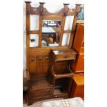 A 98cm early 20th Century Arts & Crafts oak hallstand with original coat hooks, central bevelled