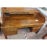 A 1.5m vintage oak roll-top desk with fitted interior enclosed by a tambour, with flanking slides