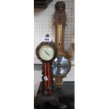 A small freestanding carved soft wood longcase style aneroid barometer - sold with an oak effect