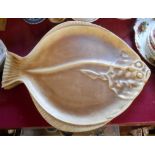 Four large pottery fish platters each in the form of a large flat fish with a decorative souffle