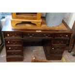 *A 1.2m reproduction stained oak twin pedestal desk with leather inset top, three frieze drawers and