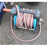 A Gardena hose reel and hose