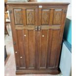 An 88cm 20th Century oak low wardrobe in the antique style with hanging space and shelves enclosed