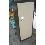 A vintage metal workshop cabinet with front cupboard door in brown livery