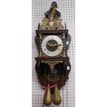 A reproduction Zan Dam ornate stained wood cased wall clock with applied cast brass decoration and