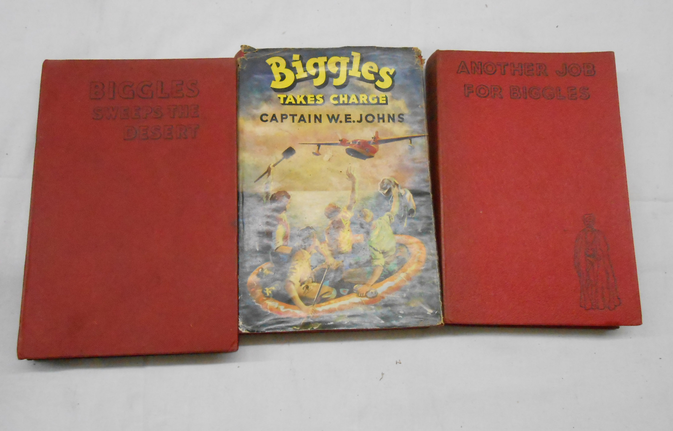 W.E. Johns: three 1st edition 'Biggles' books comprising 'Biggles Takes Charge' with remains of dust