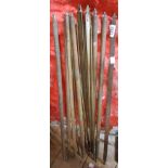 A quantity of old brass stair rods